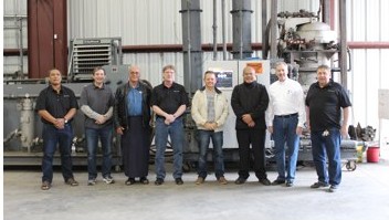 Tonga delegation with the plant team in front of processing equipment